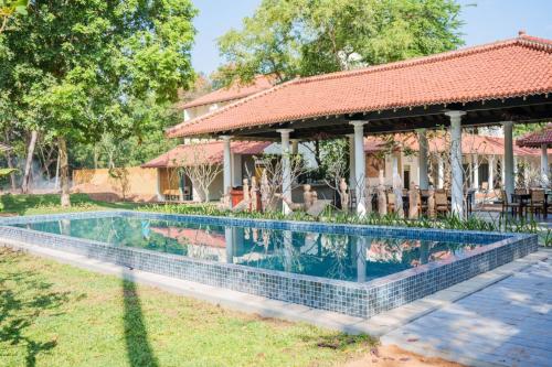een zwembad voor een huis bij Rekawa Wellness Resort in Tangalle