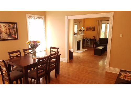 a dining room and living room with a table and chairs at The B in Louisville