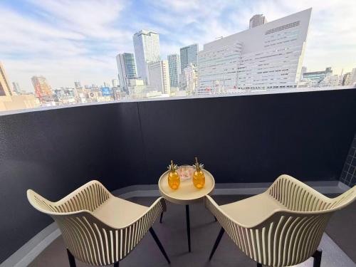a table and chairs on a balcony with a view of a city at Cozy APT Stay in Center Tokyo -SHIBUYA in Tokyo