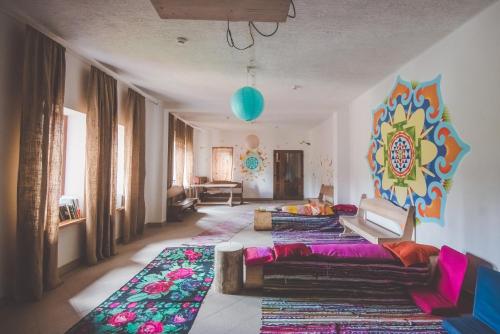 a living room with a couch and a colorful wall at Янтри in Dragobrat