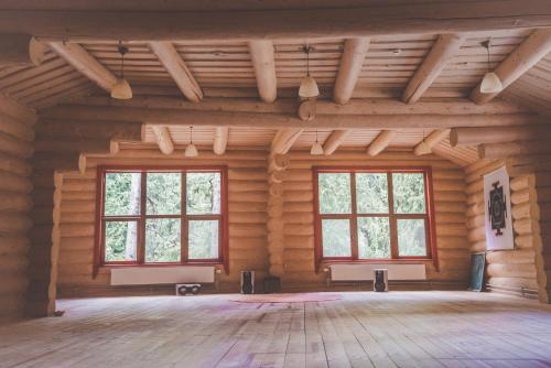 an empty room with two windows in a log cabin at Янтри in Dragobrat