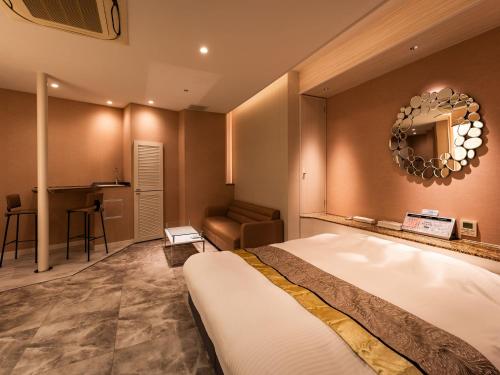 a hotel room with a bed and a desk at Hotel Le Club PLUS 1 福岡新宮 -Adult Only- in Shingū