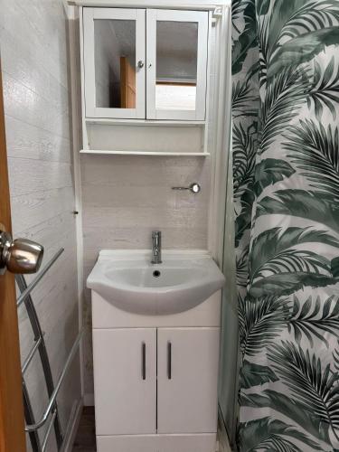 a bathroom with a sink and a cabinet at The Clarendon Hotel in Blackpool