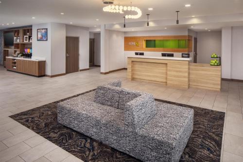 a living room with a couch and a kitchen at Home2 Suites By Hilton Memphis Downtown in Memphis