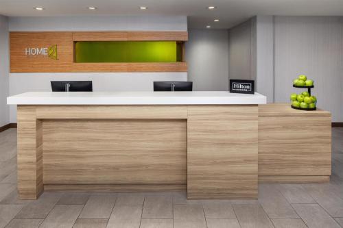 an office lobby with a counter with apples on it at Home2 Suites By Hilton Memphis Downtown in Memphis