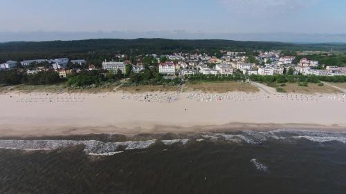 an aerial view of a beach with a crowd of people at Strandhotel Ostende in Ahlbeck