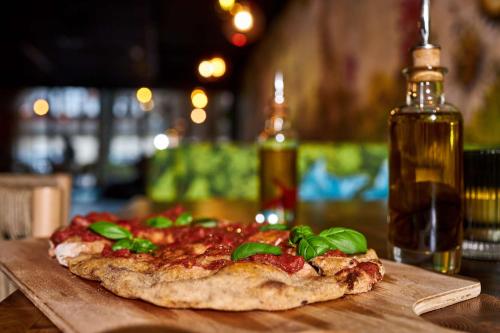 a pizza sitting on top of a wooden table at Cocoon Sendlinger Tor in Munich
