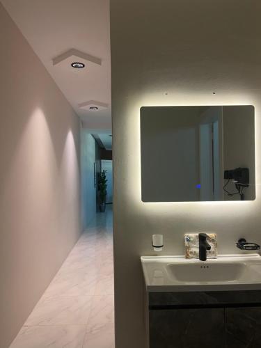 een badkamer met een wastafel en een spiegel bij نزل Rest in Hail