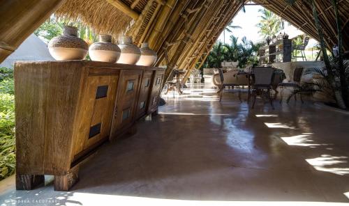 a room with vases on top of a wooden cabinet at Sandat Glamping Tents in Ubud