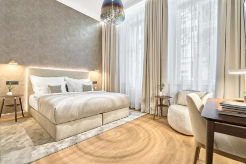 a hotel room with a bed and a desk at Villa Patriot Boutique Hotel in Mariánské Lázně