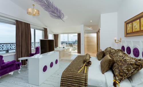ein Wohnzimmer mit einem Sofa und einem TV in der Unterkunft Wise Hotel & Spa - Adults Only in Antalya