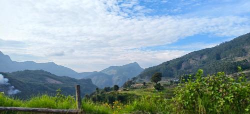 a view of a valley with mountains in the background at Misty Colina in Kottakamboor