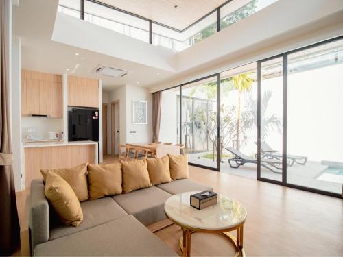 a living room with a couch and a table at Elegant Aileen 3Bed Pool Villa P3VC8 Naithon in Phuket