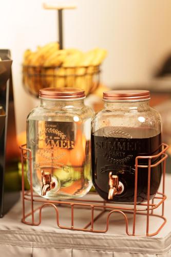 Twee wijnflessen staan op een wijnrek. bij Garni Hotel Mediteraneo in Novi Sad