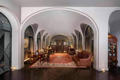 an archway in a building with chairs and tables at Hotel Muse Bangkok, Autograph Collection by Marriott in Bangkok