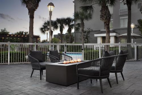 a group of chairs and a table with a fire pit at Homewood Suites by Hilton Orlando Airport in Orlando
