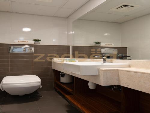 a bathroom with a sink and a toilet at ZAPBED HOUSE -1 BR In Pacific Tower Al Marjan Island With Beach Access Ras Al Khaimah in Ras al Khaimah