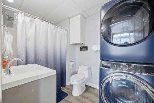 a bathroom with a washing machine and a toilet at Waterfront Walk Out with Private Terrace in Groton