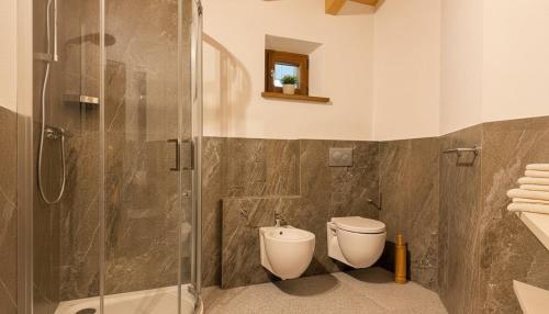 a bathroom with a shower and a toilet at Paradiso di Grosio - mansarda con vista montagne in Grosio