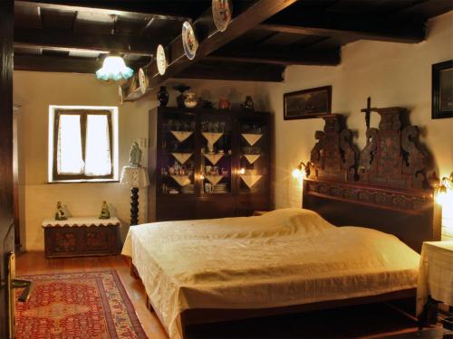 a bedroom with a large bed and a window at Natura Vendégház in Pázmánd