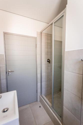 a bathroom with a shower and a sink at Modern 2 bed apartment - TH61 in George