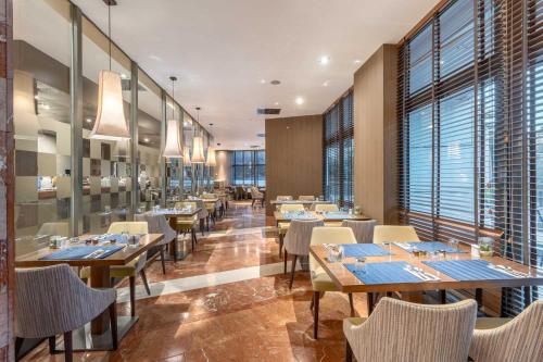 马德里米拉斯拉欧洲之星套房酒店的一家有桌椅和大窗户的餐厅