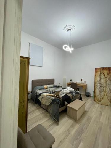 a bedroom with a bed and a desk and a chair at Salinelle Home in Paterno