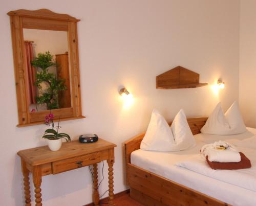 a hotel room with two beds and a mirror at Hotel Brockenstübchen in Schierke