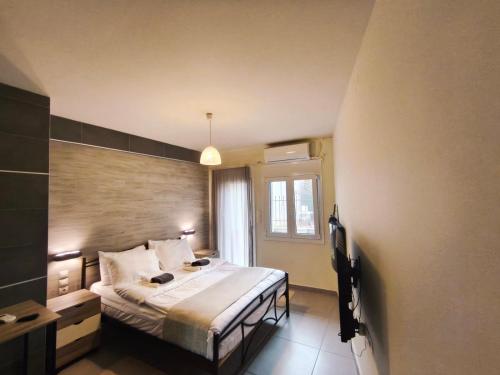a bedroom with a bed and a window at peramalux in Ioannina
