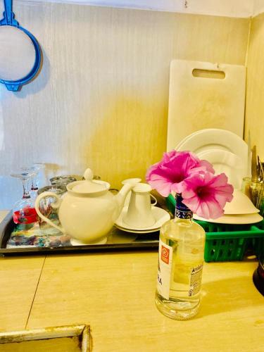 a counter top with a bottle of oil and a flower at Sea Garden Beach Resort in Habaraduwa Central