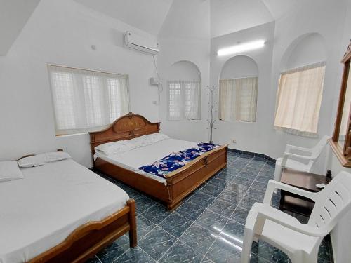 Postel nebo postele na pokoji v ubytování Guruvayur Agraharam Homestay