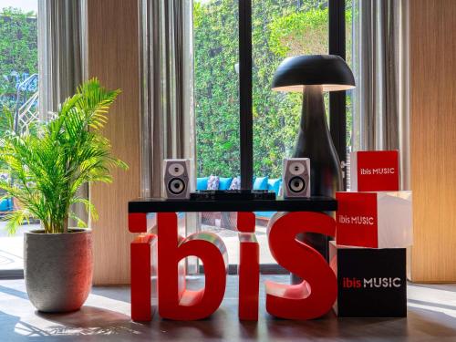a table with a sign that says hot and a plant at ibis Dubai World Trade Centre in Dubai