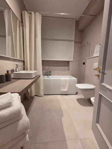 a bathroom with a tub and a sink and a toilet at Mater Domini in Chieti
