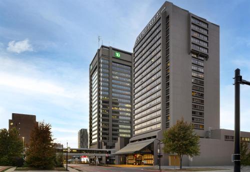 a tall building with a green sign on it at Doubletree by Hilton London in London