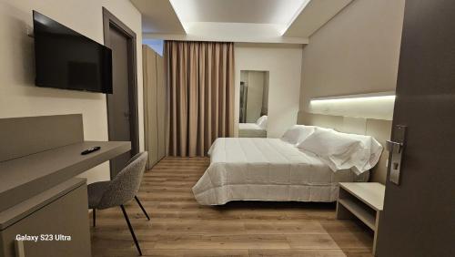 a hotel room with a bed and a television at Hotel del Sole-Aversa in Aversa