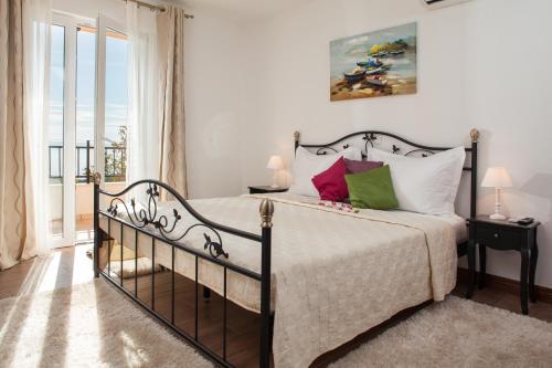 a bedroom with a bed and a window at Villa Berina in Makarska