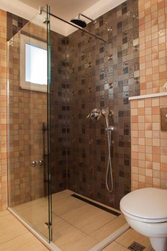 a bathroom with a shower with a toilet at Villa Berina in Makarska