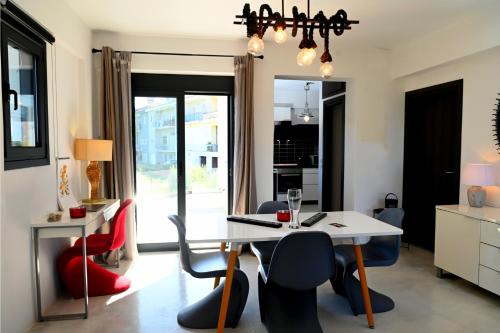 a dining room with a white table and chairs at Hydra House Nafplio in Myloi