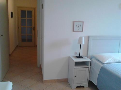 a bedroom with a bed and a lamp on a night stand at Bed And Breakfast Catherina in Ponsacco