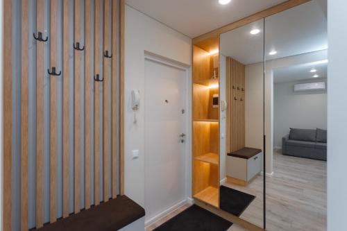 a hallway with a glass door leading to a bedroom at HomeRent Petru Zadnipru in Chişinău