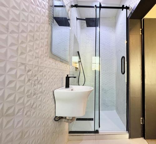 a bathroom with a sink and a shower at The Colony in Mama