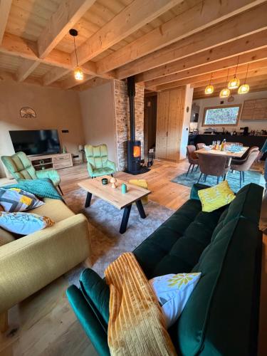 a living room with two couches and a table at Chalet cosy avec vue montagne proche La Clusaz & Le Grand-Bornand in Saint-Jean-de-Sixt