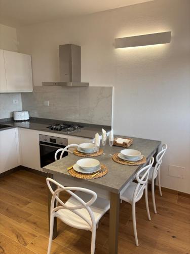 a kitchen with a table with chairs and a stove at Mugello Circuit & Florence charm in Scarperia