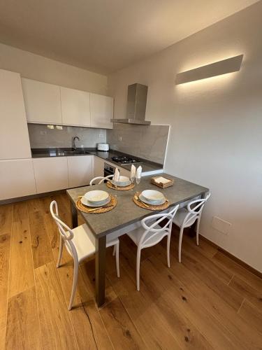 a kitchen with a table and chairs in a kitchen at Mugello Circuit & Florence charm in Scarperia