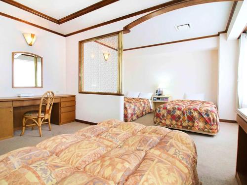 Postel nebo postele na pokoji v ubytování 寝屋川トレンドホテル