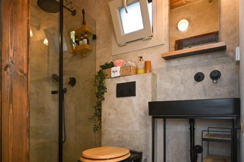 a small bathroom with a toilet and a shower at בקתת שקד Shaked Cabin in Natur