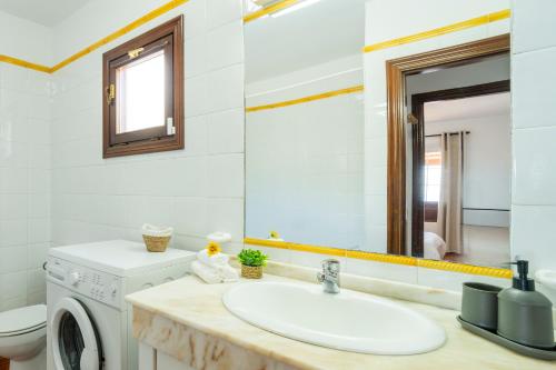a bathroom with a sink and a washing machine at CHL Serycam Breña Baja, infinity views in Breña Baja