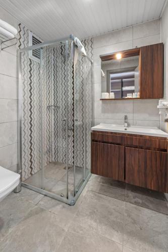 a bathroom with a shower and a sink at Club Hotel Rama in Beldibi