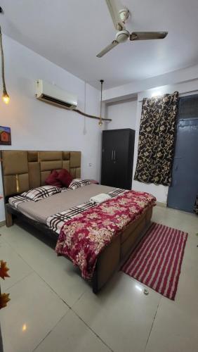 a bedroom with a bed in a room with a rug at Vishwanathan in Varanasi