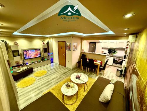 a living room with a couch and a table at Holiday Home Zelena Oaza in Sarajevo